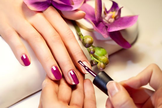 "A professional nail artist at Shrees Beauty Parlour in Kathreguppe, Banashankari 3rd Stage, Bengaluru, creating intricate nail art designs on a client's nails."