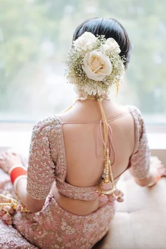 "A bridal hairstyle from behind, showcasing intricate styling, complemented by a saree, at Shrees Beauty Parlour in Kathreguppe, Banashankari 3rd Stage, Bengaluru."