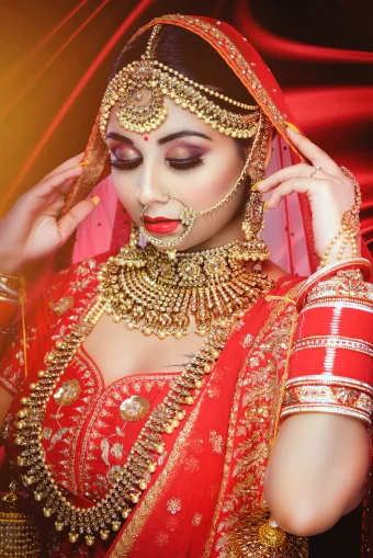 A bridal model in a stunning red bridal dress at Shrees Beauty Parlour in Kathreguppe, Banashankari 3rd Stage, Bengaluru."